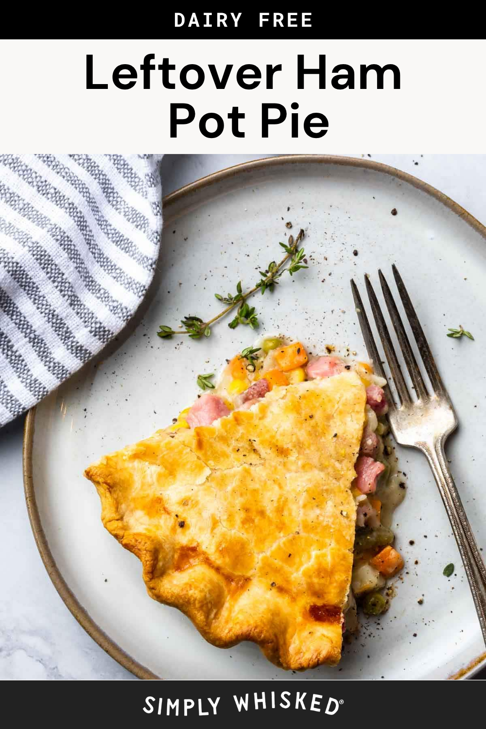 A slice of leftover ham pot pie sits on a plate with a fork, garnished with fresh herbs. A striped napkin is neatly placed beside the plate. The text above reads Dairy Free Leftover Ham Pot Pie.
