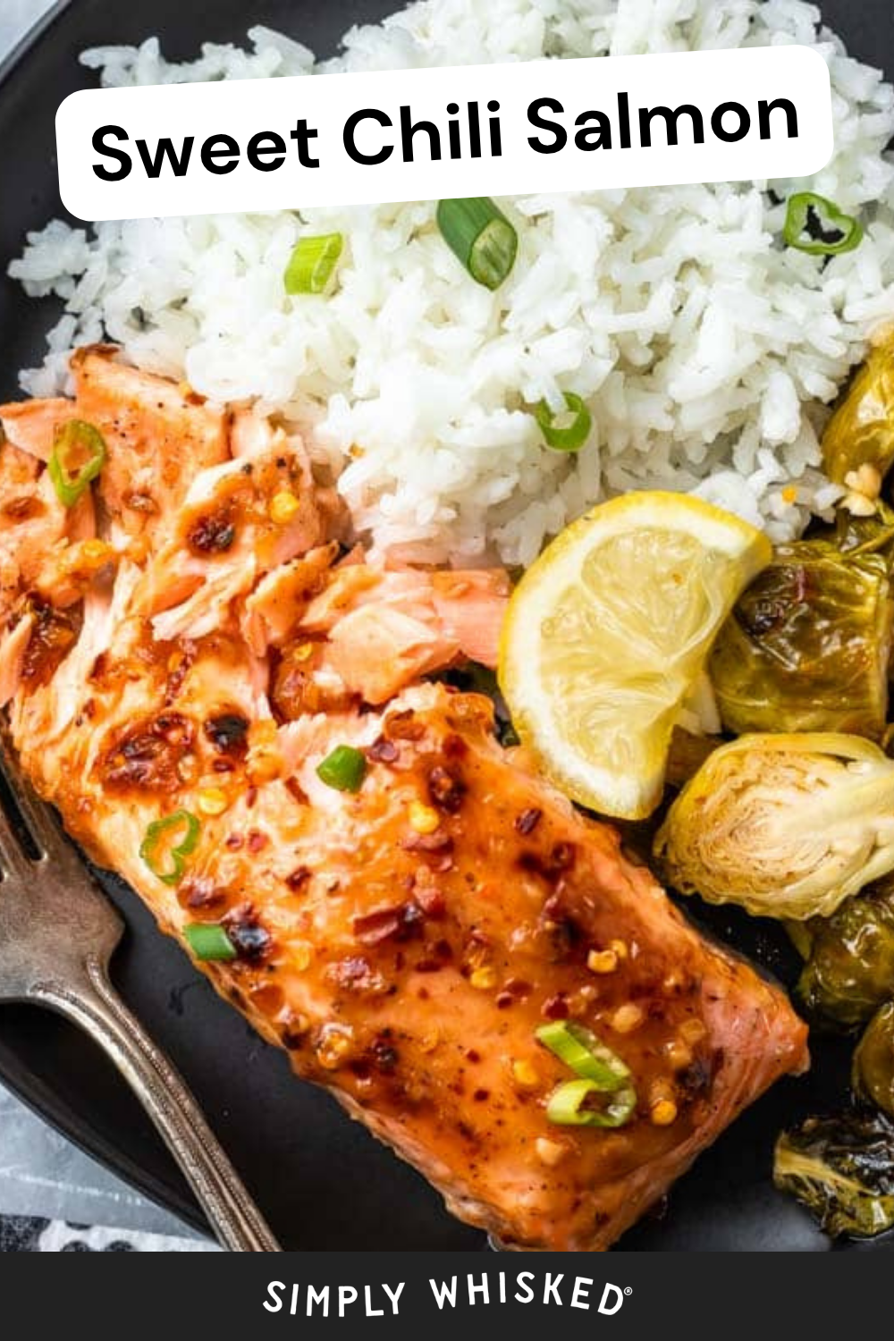 A plate with sweet chili salmon, white rice, roasted Brussels sprouts, lemon slices, and a green onion garnish. A fork rests on the plate. Text reads Sweet Chili Salmon and Simply Whisked. This vibrant dish highlights the bold flavors of sweet chili salmon paired perfectly with fresh accompaniments.