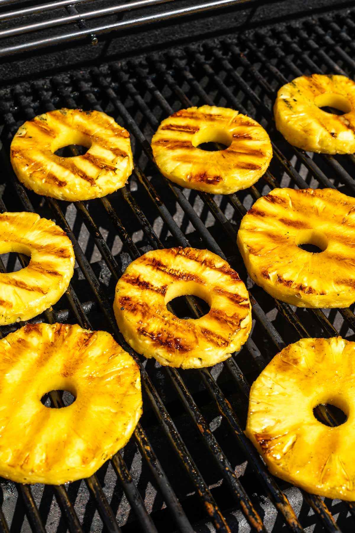 Pineapple slices with grill marks on a grill