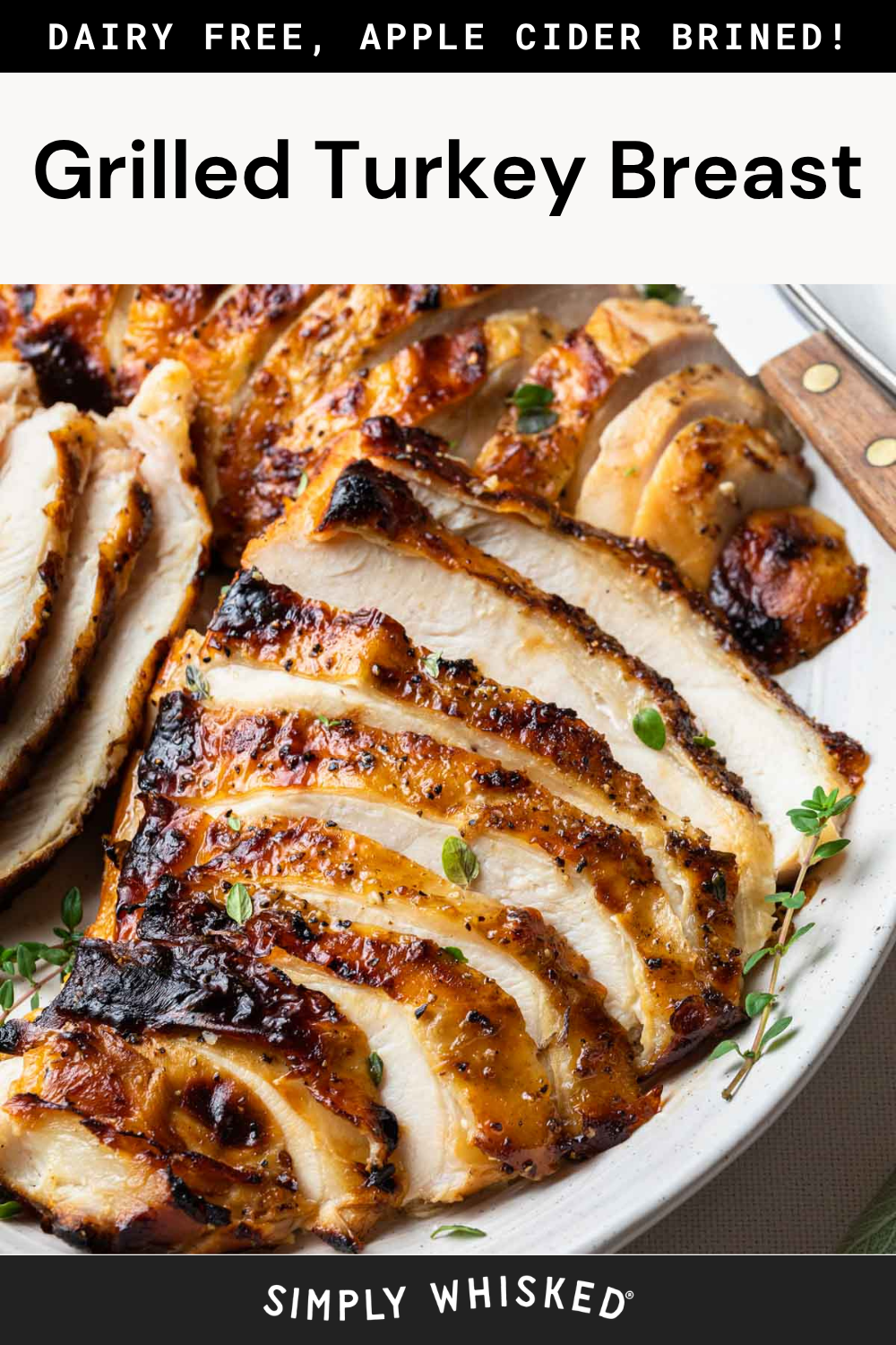 Sliced grilled turkey breast, brined in apple cider, garnished with fresh herbs on a white plate. The turkey breast is golden-brown, juicy, and tender. Text above reads: Dairy Free, Apple Cider Brined! Grilled Turkey Breast.