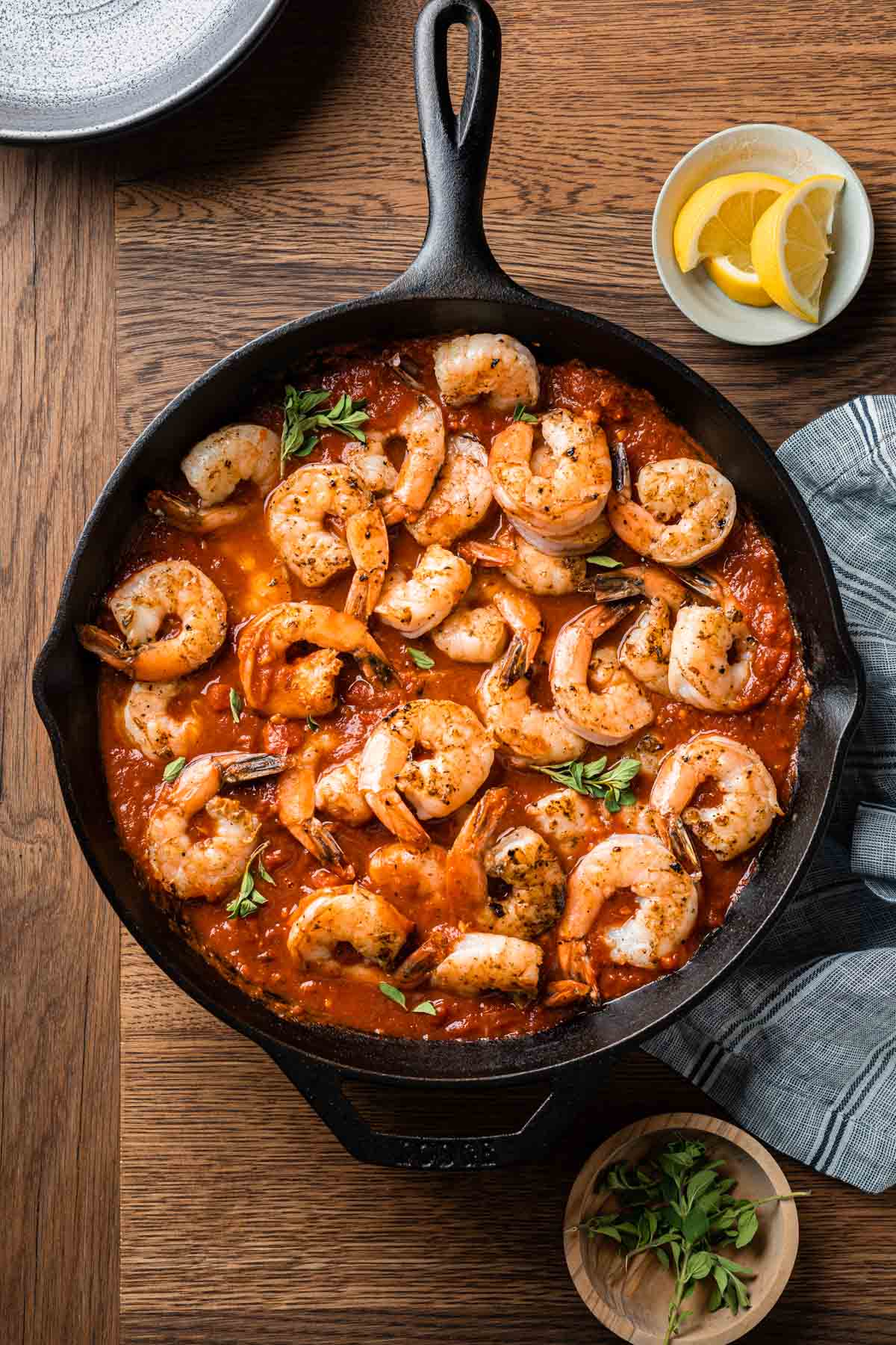 Overhead shot of shrimp in tomato sauce in a cast iron skillet. 