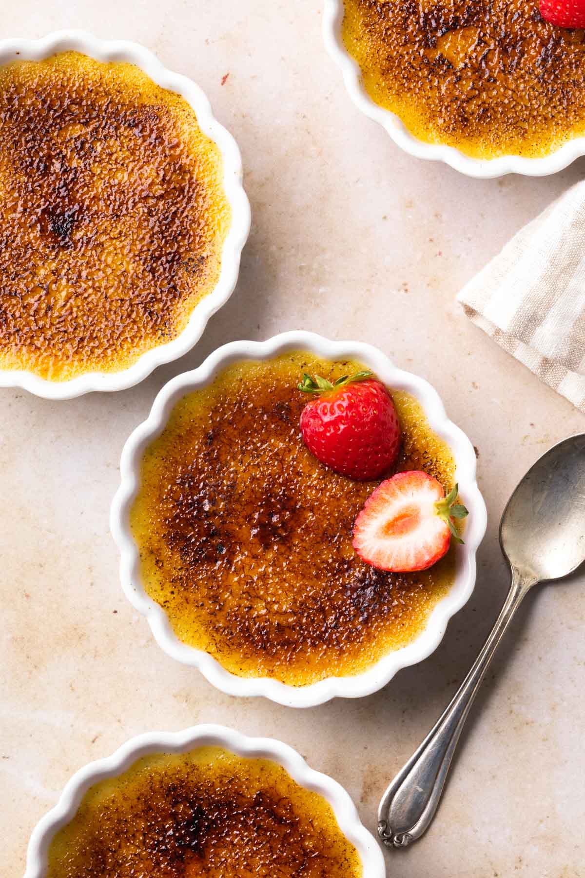 Creme brulee in a dish with strawberries. 
