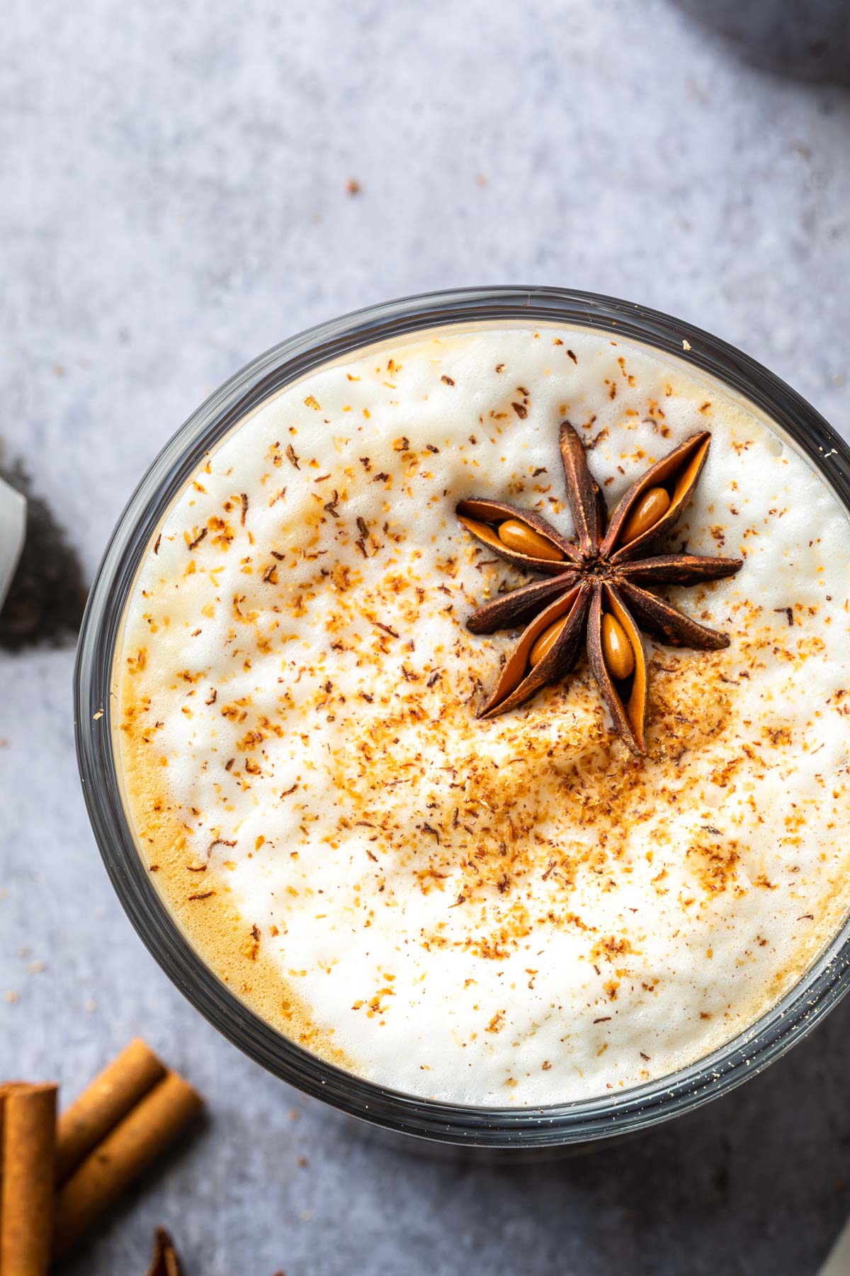 Close up of a dirty chai latte with a star anise garnish. 