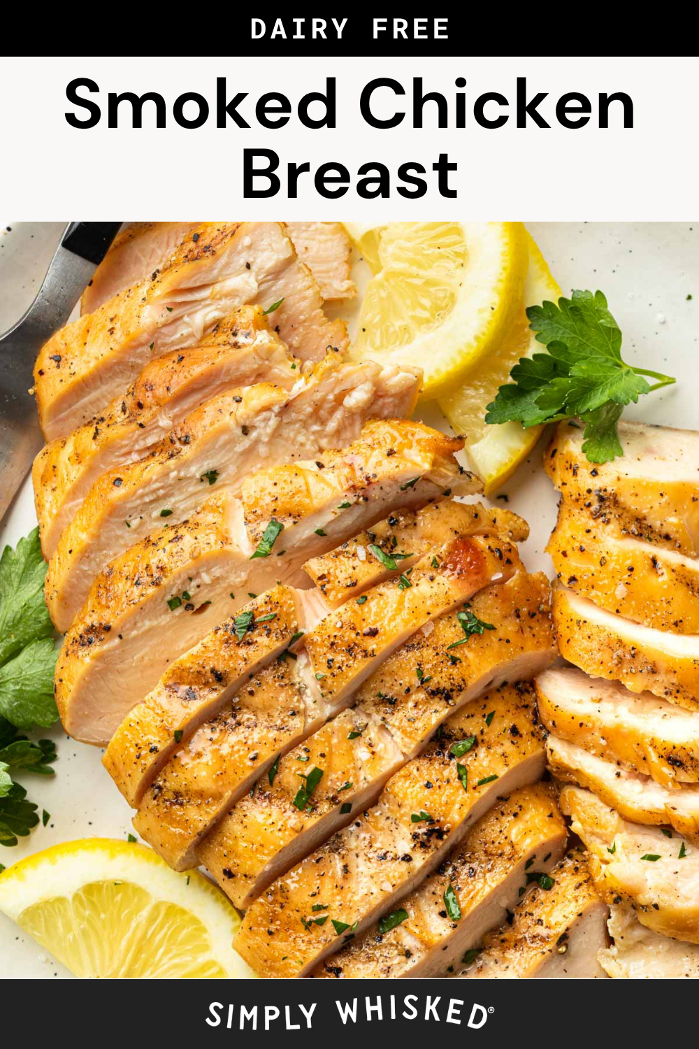 Sliced smoked chicken breast is garnished with parsley and lemon wedges on a white plate, with a fork at the top left. The text reads Dairy Free Smoked Chicken Breast and Simply Whisked.