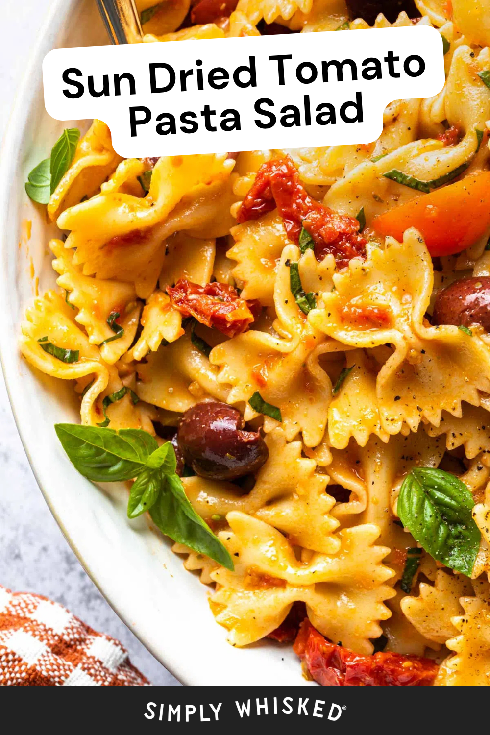 Close-up of Sun Dried Tomato Pasta Salad with bow-tie pasta, sun-dried tomatoes, olives, fresh basil, and a light dressing. Text overlay reads Sun Dried Tomato Pasta Salad.