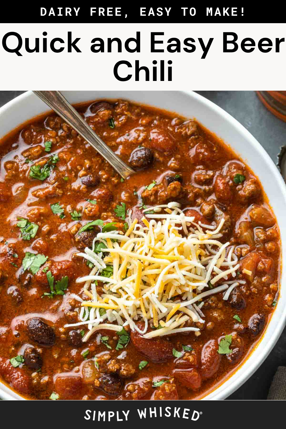 Bowl of beer chili topped with shredded cheese and cilantro, with a spoon inside. The chili contains beans, ground meat, and tomatoes. Text above reads Quick and Easy Beer Chili and Dairy Free, Easy to Make!.