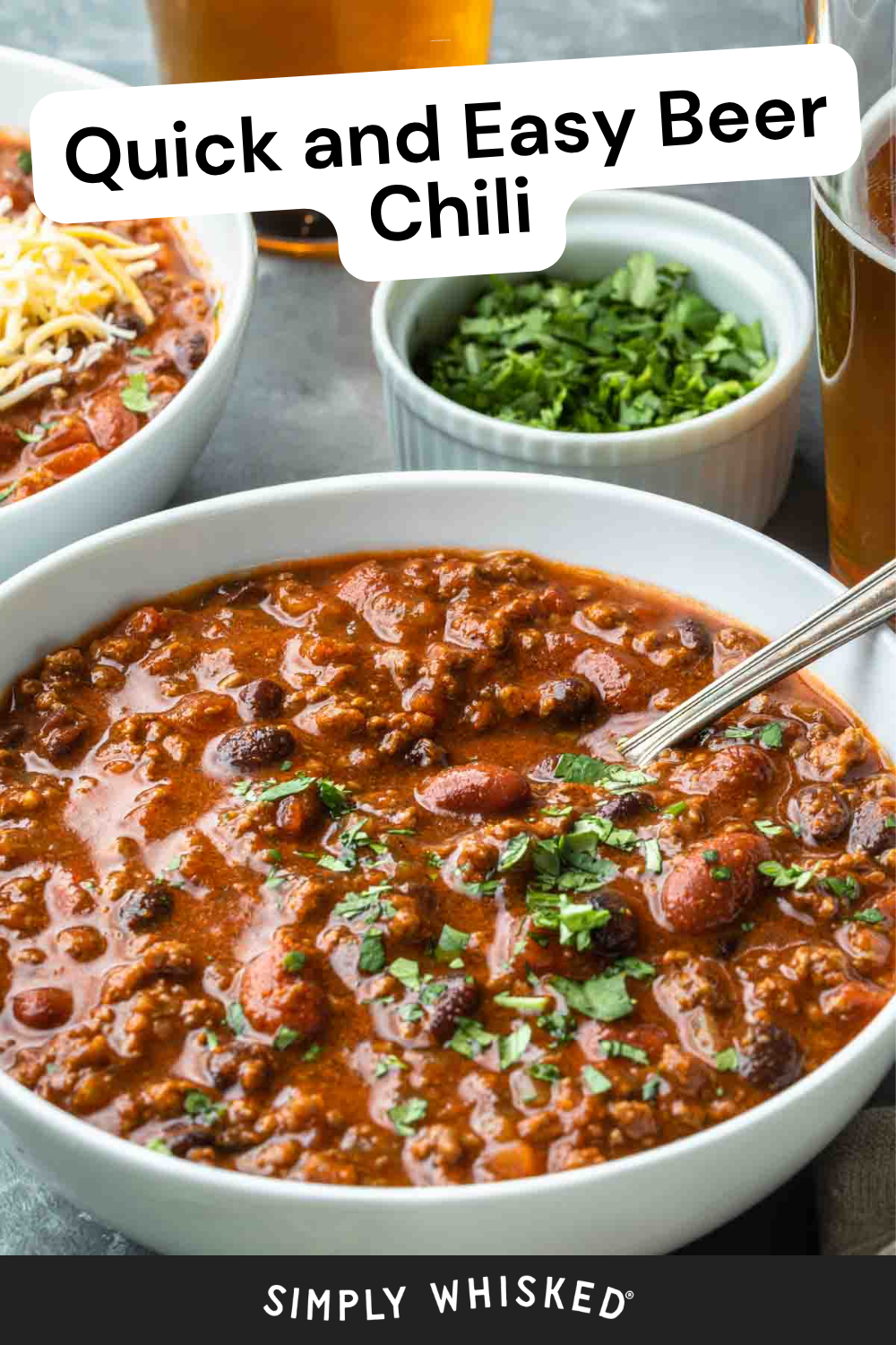 A bowl of hearty beer chili with beans and ground meat, topped with chopped herbs, sits next to another bowl, a small dish of cilantro, and glasses of beer. Text reads Quick and Easy Beer Chili and Simply Whisked.