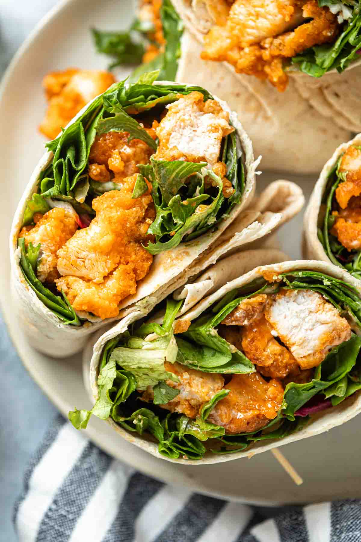Close up of a buffalo chicken wrap on a plate. 