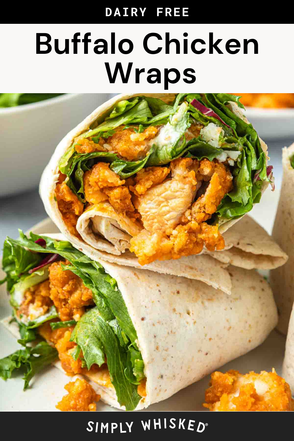 A close-up of Buffalo Chicken Wraps showcases two wraps filled with crispy chicken, leafy greens, and dairy-free sauce, all wrapped in tortillas and placed on a white surface.