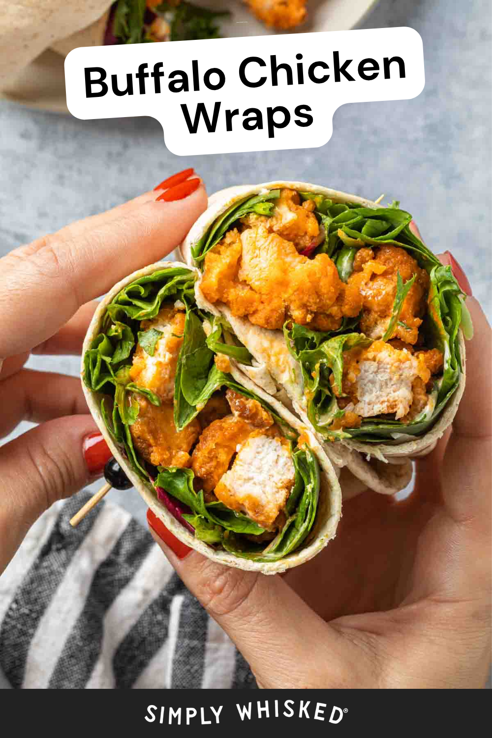 A person holds a sliced Buffalo Chicken Wrap filled with tender chicken, fresh greens, and zesty sauce. The text on the image reads Buffalo Chicken Wraps at the top and Simply Whisked at the bottom.