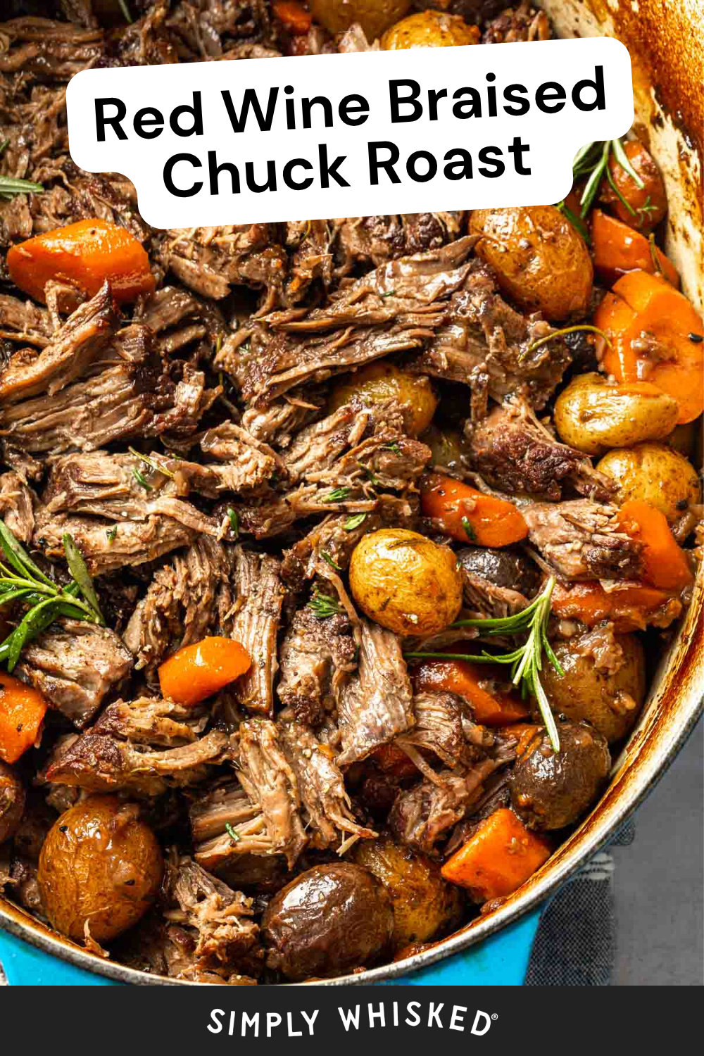 A close-up of braised chuck roast simmered in red wine, featuring tender chunks of beef, baby potatoes, carrots, and sprigs of rosemary in a pot. Text overlay reads, Red Wine Braised Chuck Roast.