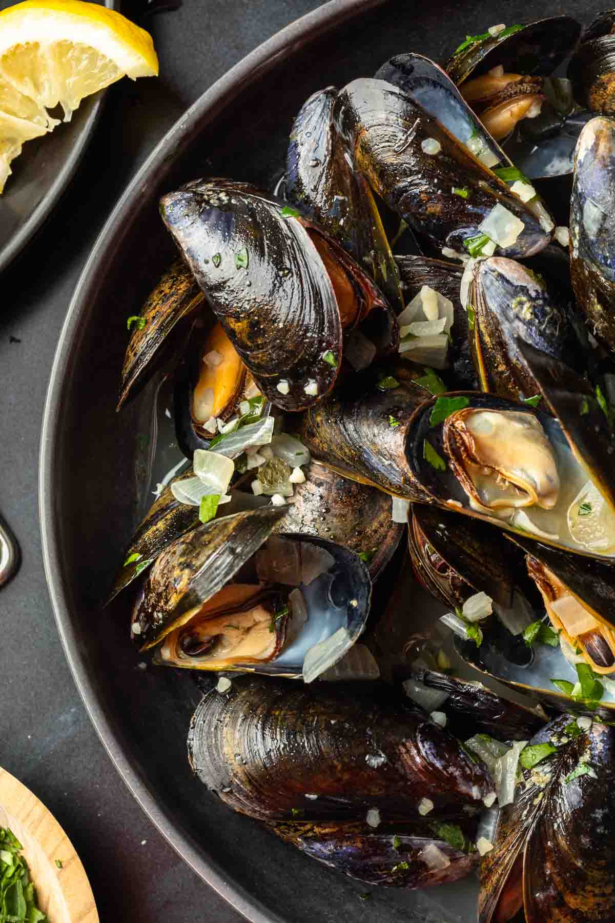 Close up of belgian beer steamed mussels in a serving bowl. 