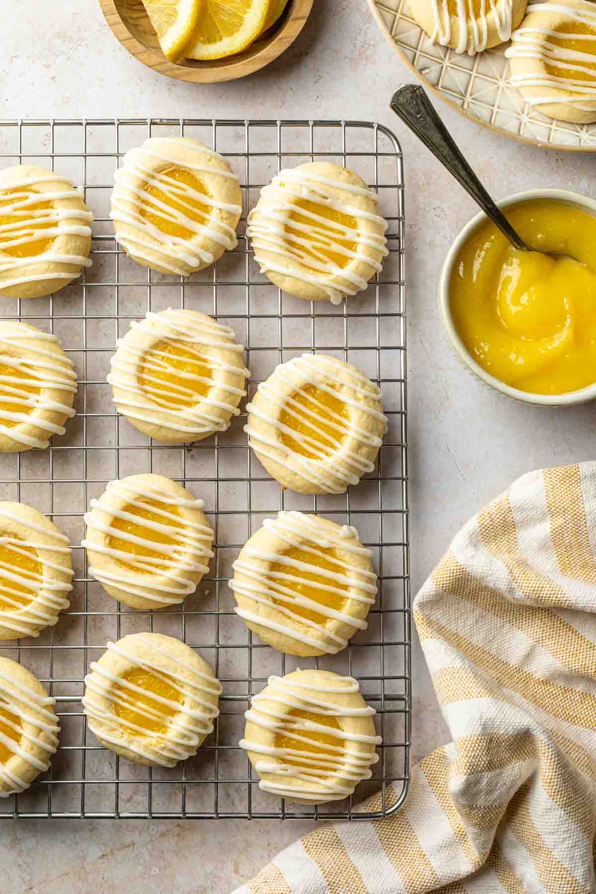 Cookies on a cooling rack next to a bowl of lemon curd. 