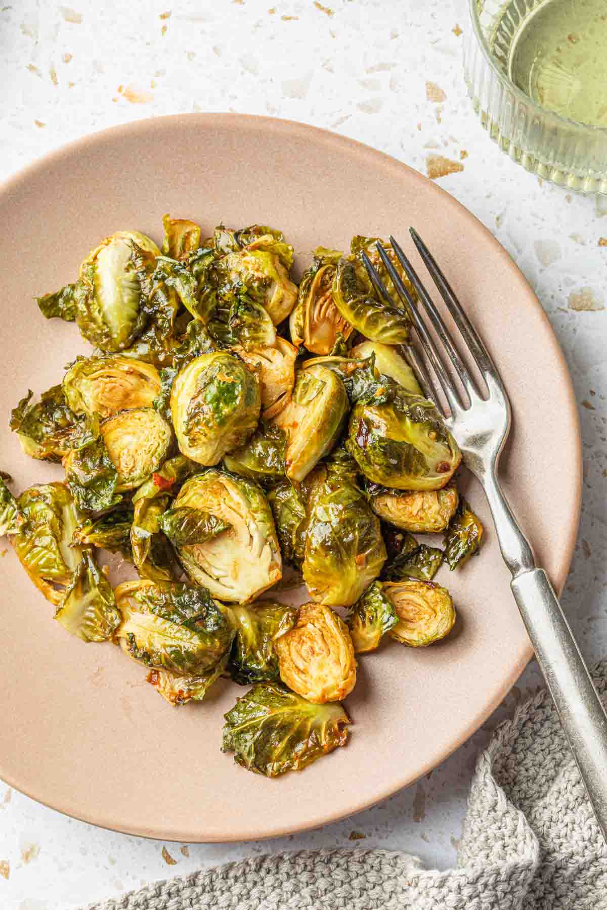 Smoked brussels sprouts on a plate with a fork. 