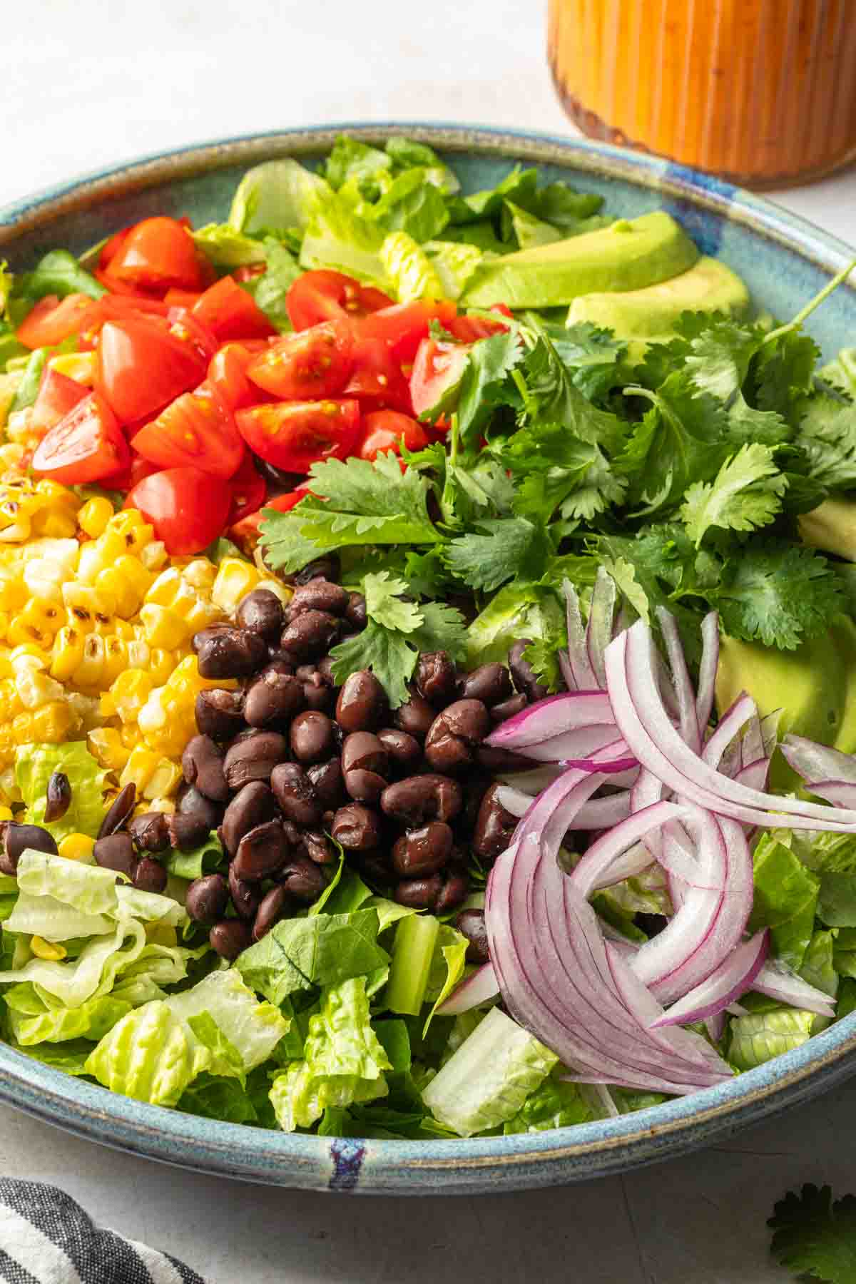 Close up of a salad in a serving bowl showing the fresh ingredients. 