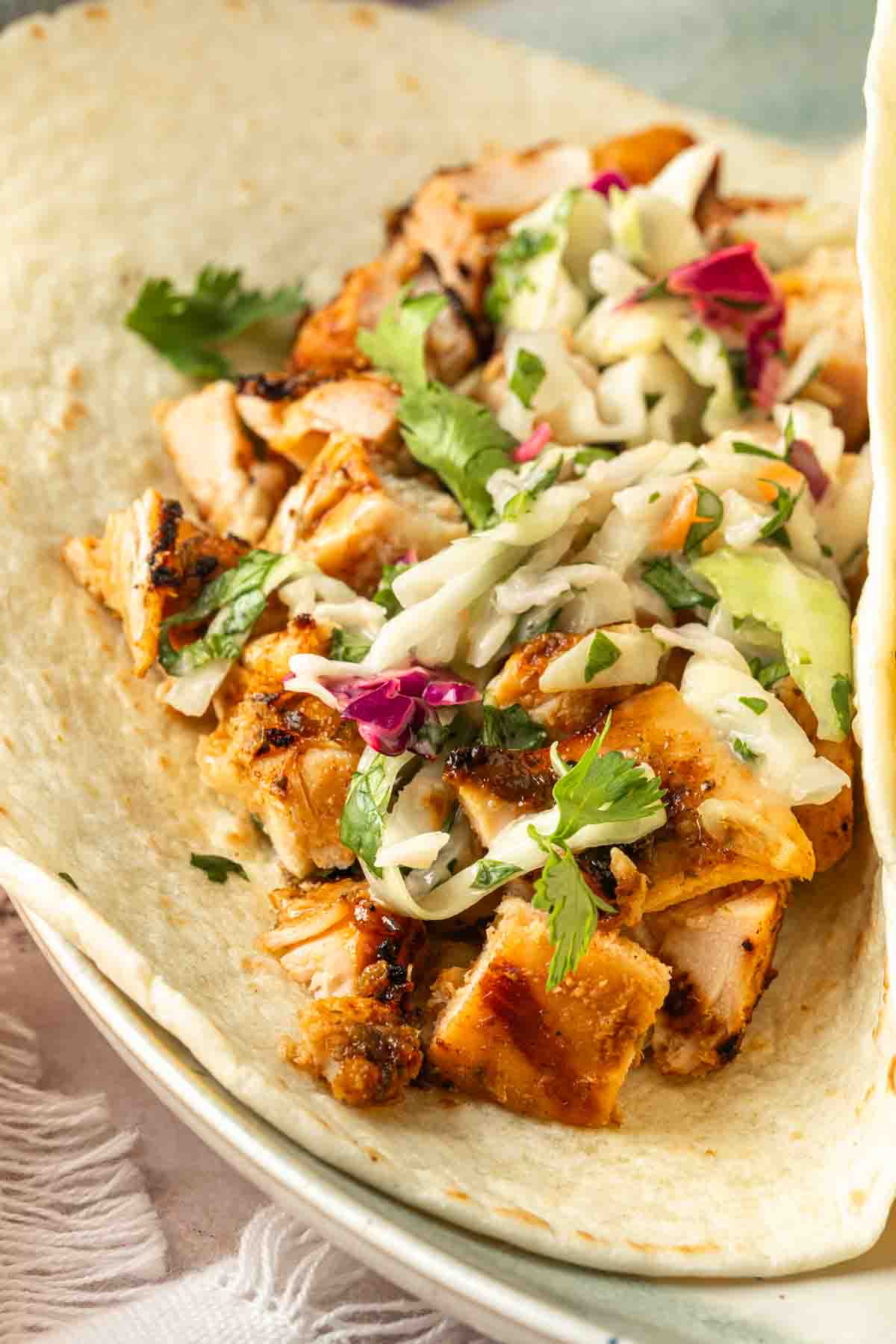 A taco with chicken and slaw. 