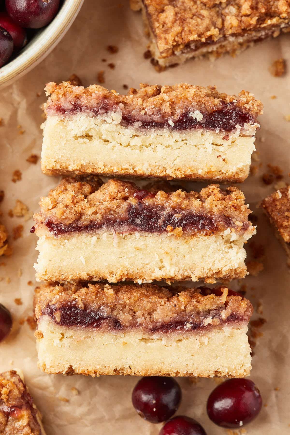 Close up of sliced shortbread cakes, made with fruit preserves and a streusel topping. 
