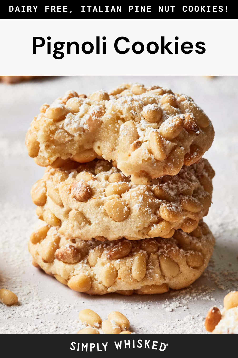 Three pignoli cookies stacked on a light surface, generously covered in pine nuts and dusted with powdered sugar. This mouthwatering image showcases classic Pignoli Cookies and promotes a dairy-free, Italian pine nut cookie recipe from Simply Whisked.