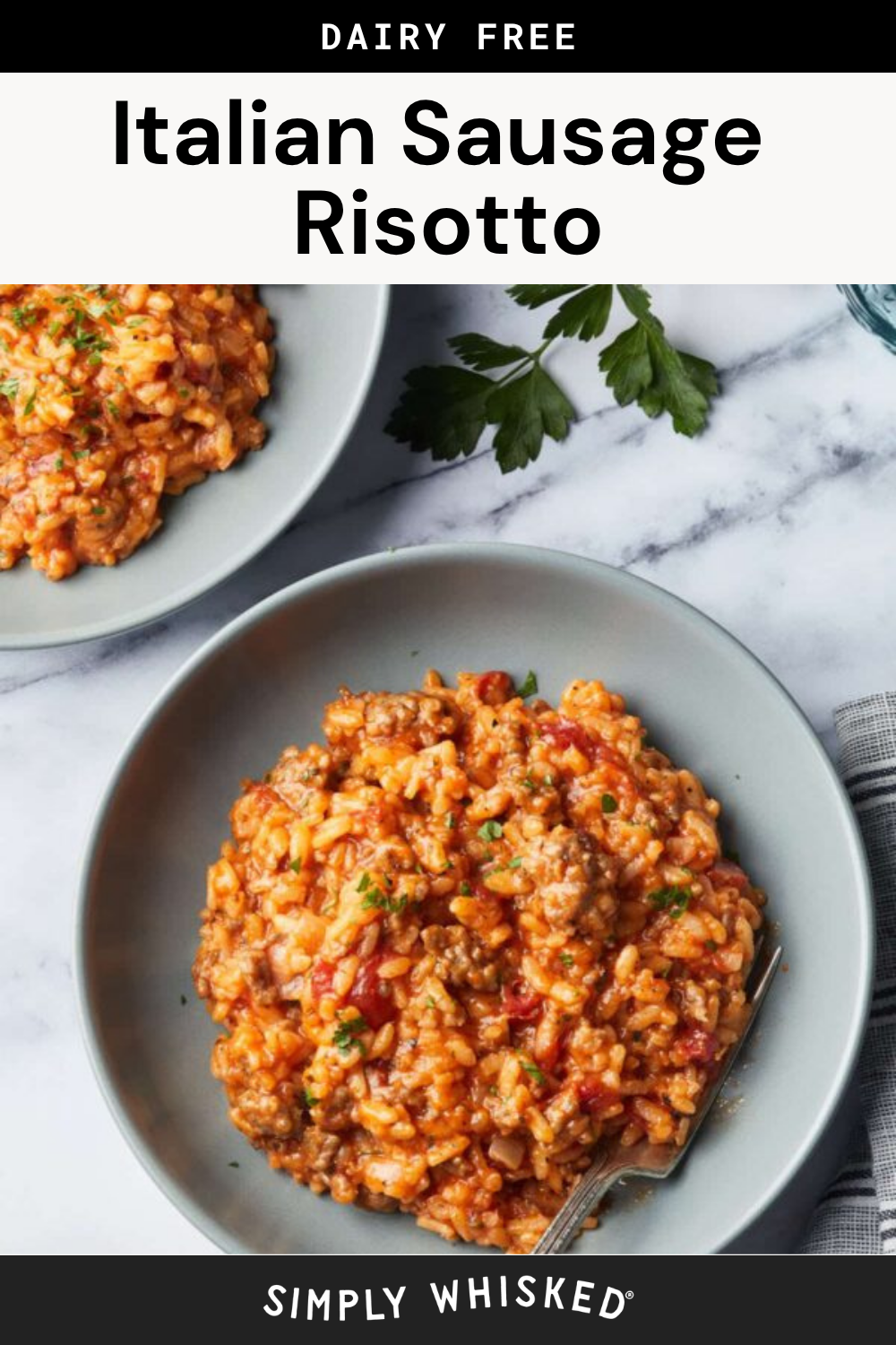 A bowl of creamy sausage risotto topped with herbs, placed on a marble surface next to a sprig of parsley and another plate of risotto. Text above reads Dairy Free Italian Sausage Risotto.