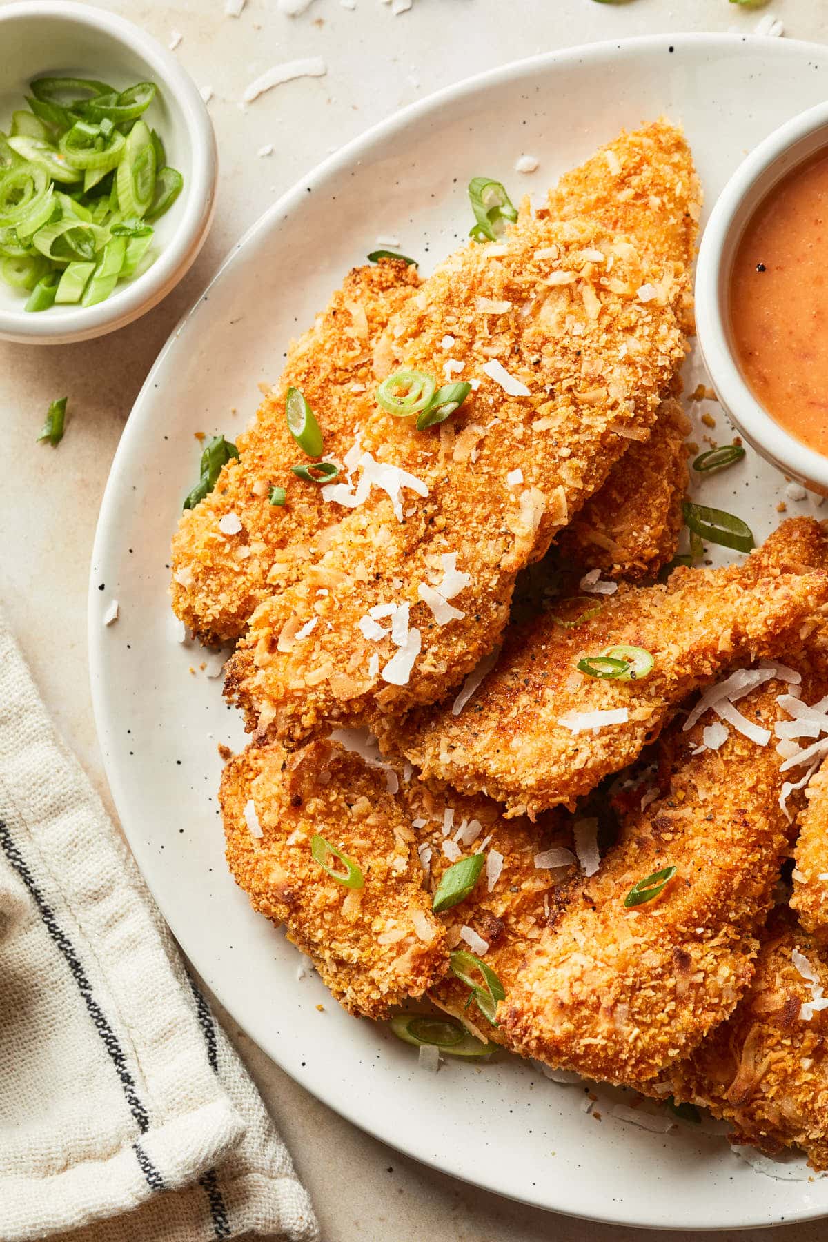 Close up of breaded chicken on a plate.