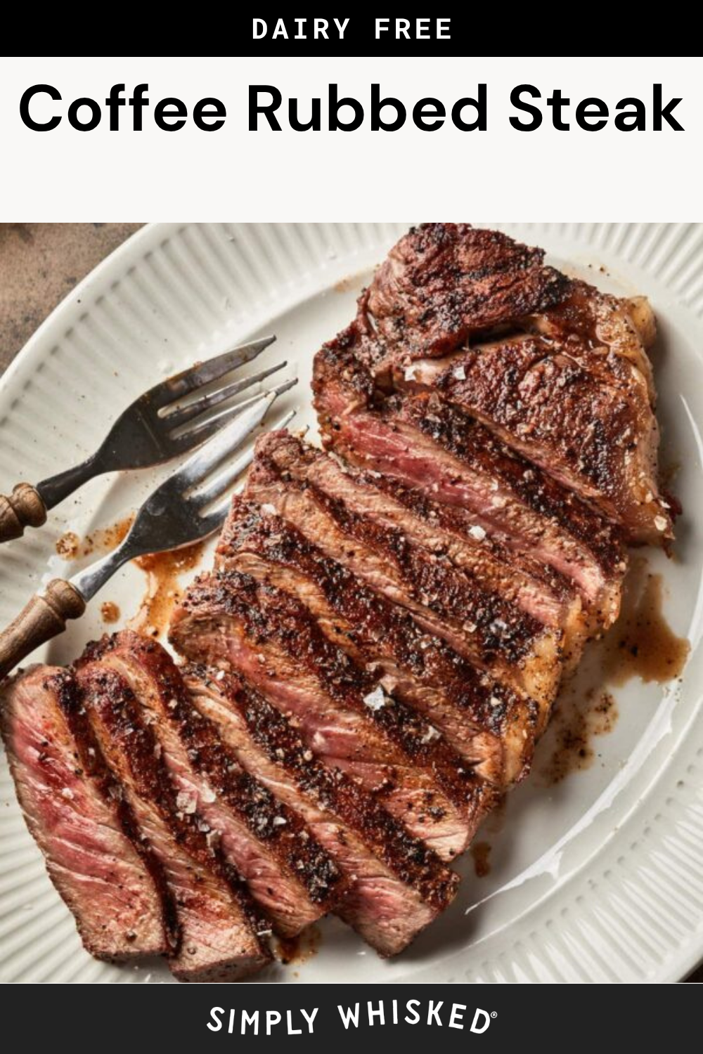 A sliced, medium-rare coffee rubbed steak sits on a white plate, flanked by two vintage forks. Text on the image reads Dairy Free Coffee Rubbed Steak and Simply Whisked.