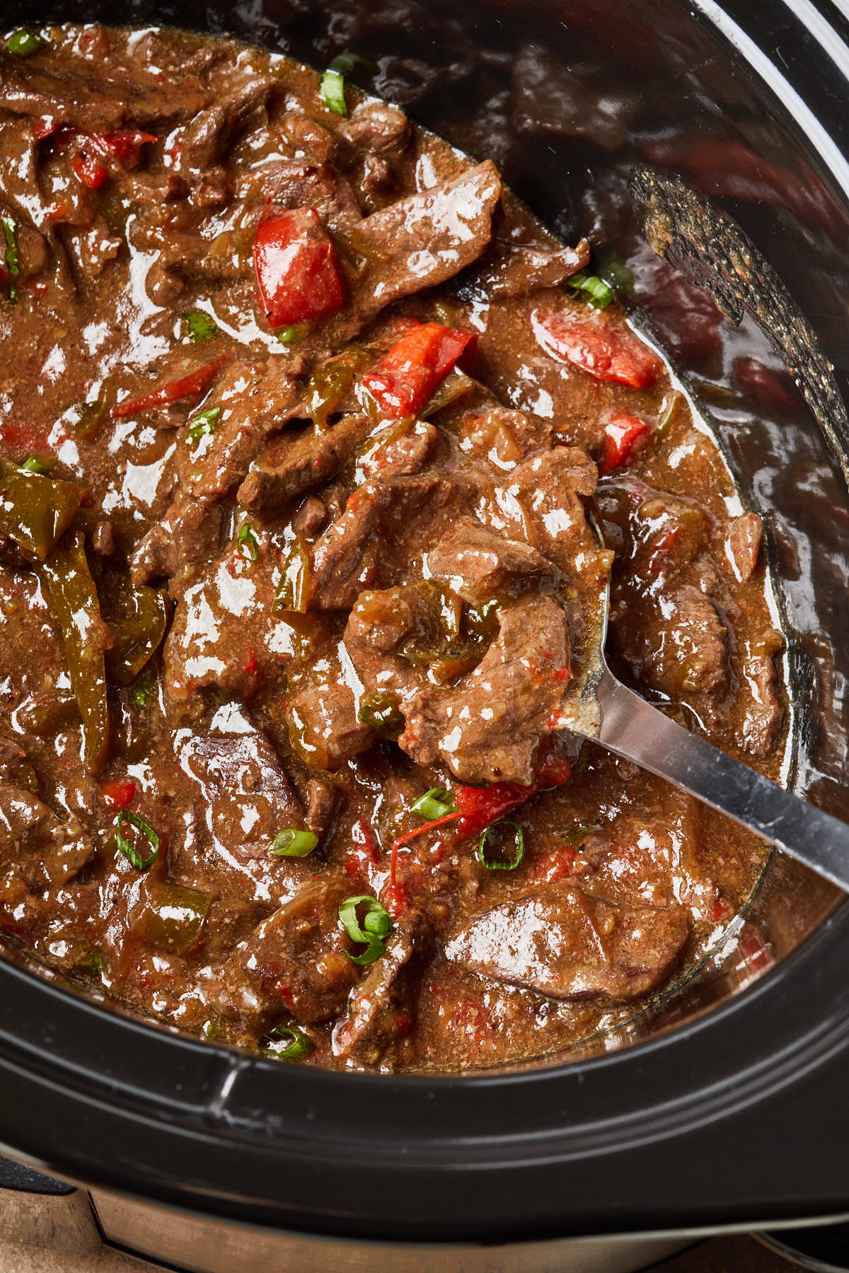 Close up of pepper steak in a slow cooker.