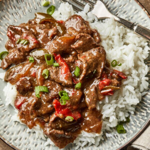 Pepper steak served over a bed of white jasmine rice.