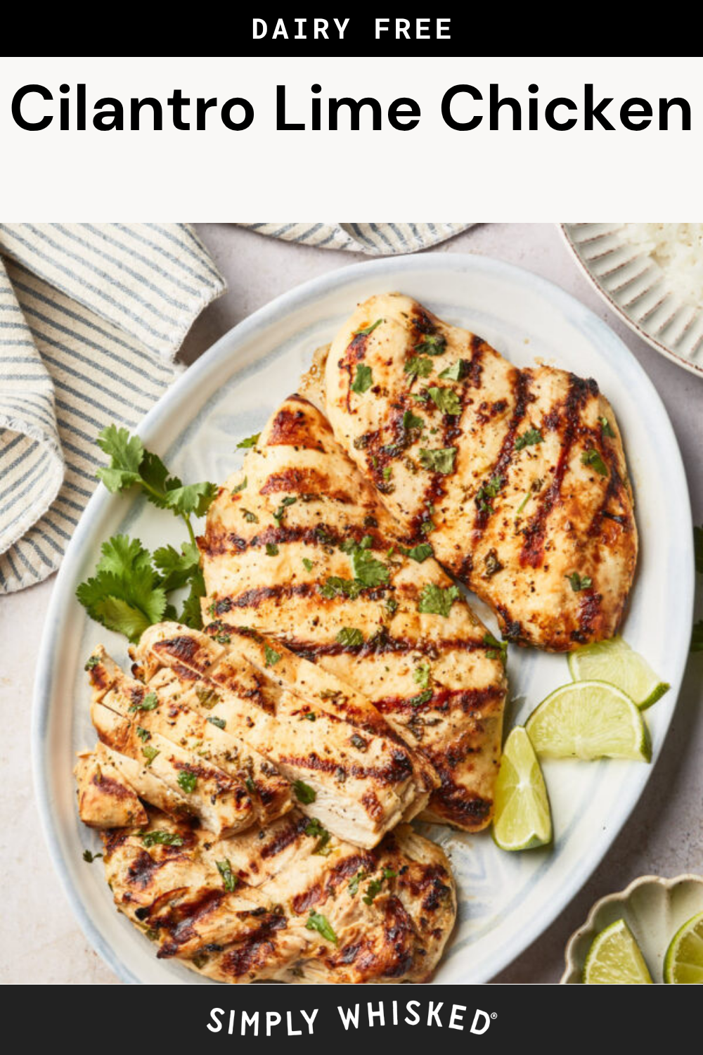 Cilantro Lime Chicken breasts are grilled to perfection, garnished with chopped cilantro, and served on a platter with lime wedges and fresh cilantro, next to a striped kitchen towel.