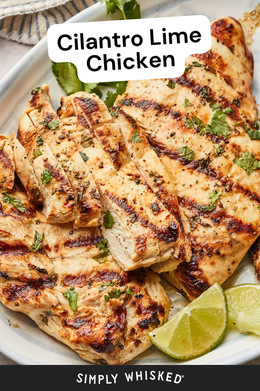 Grilled Cilantro Lime Chicken breasts, some sliced, garnished with fresh cilantro and served with lime wedges on a white plate. Text reads Cilantro Lime Chicken at the top and Simply Whisked at the bottom.