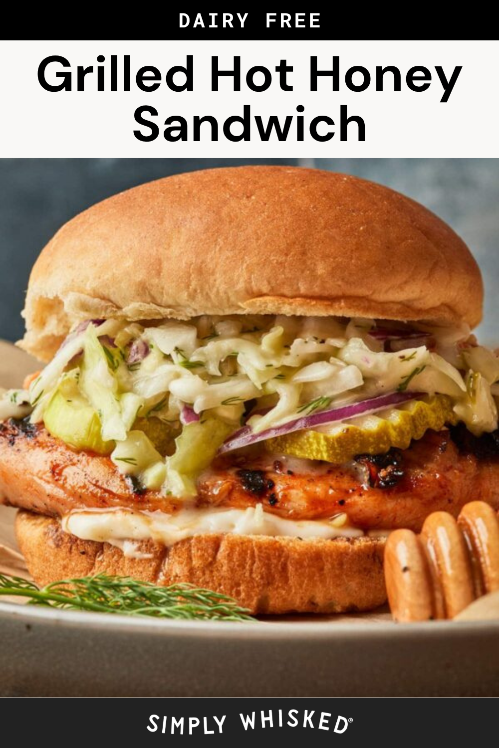 A Hot Honey Chicken Sandwich on a bun, topped with coleslaw and pickle slices, with spicy sauce dripping out the side. The sandwich is on a plate, and a honey dipper is in the foreground. Text reads Grilled Hot Honey Sandwich.