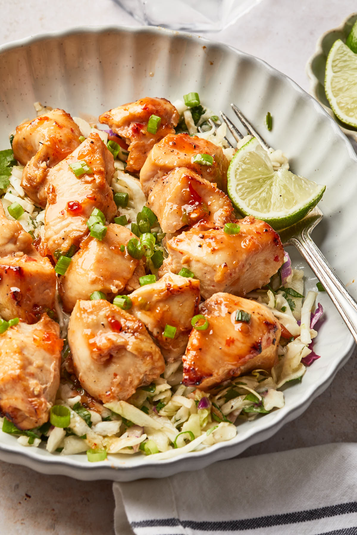grilled chicken skewers on a plate served over a bed of rice.