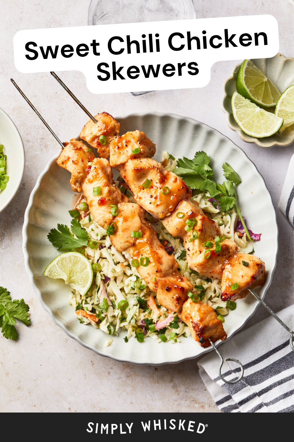 Two grilled Sweet Chili Chicken skewers served over rice with chopped herbs, garnished with lime wedges and cilantro on a white plate. A striped napkin and a bowl of limes are nearby. Text reads Sweet Chili Chicken Skewers.