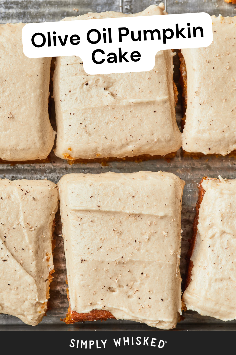 Squares of Olive Oil Pumpkin Cake with a light brown olive oil frosting are arranged on a baking tray. A label at the top reads Olive Oil Pumpkin Cake and Simply Whisked is written at the bottom.