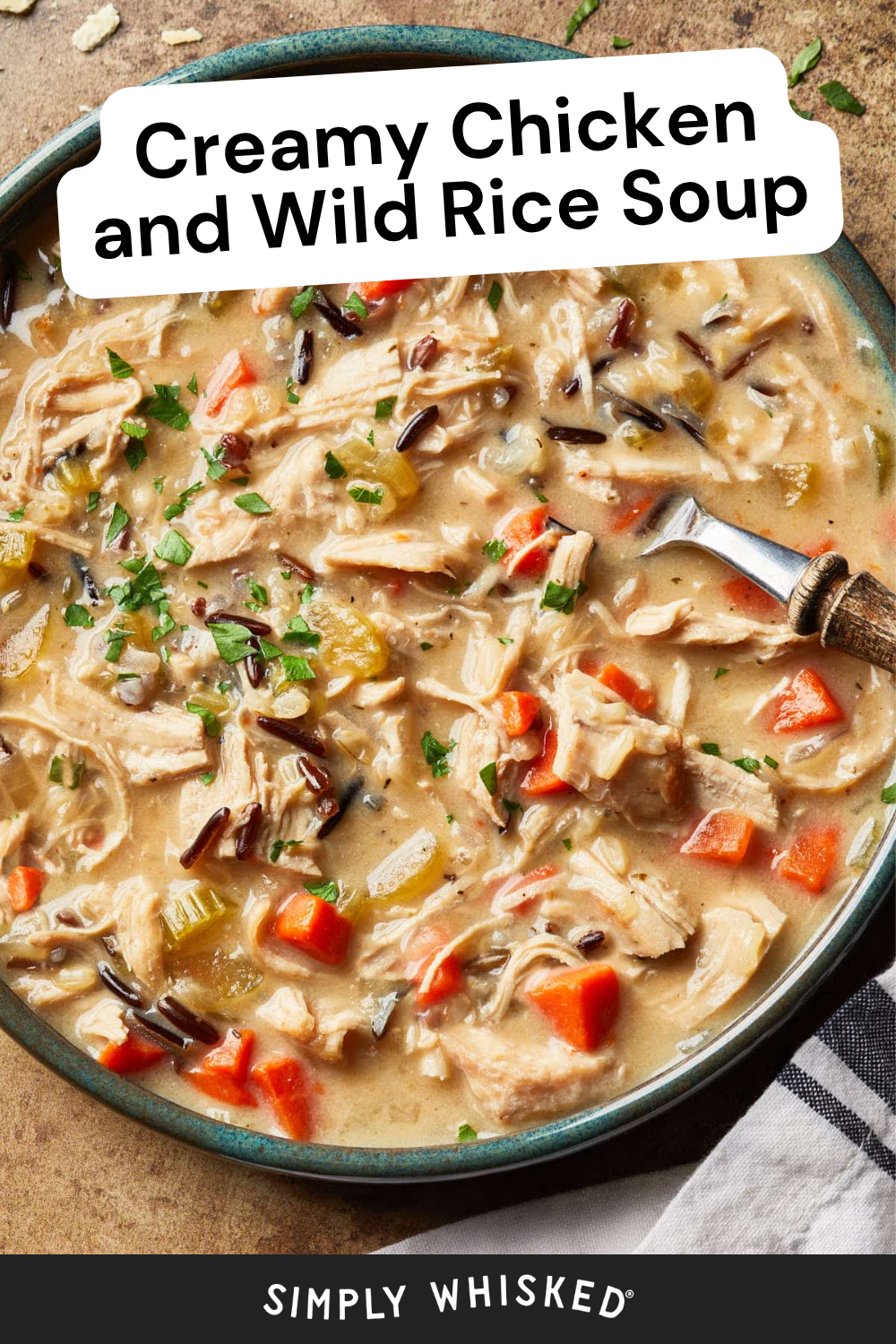 A bowl of creamy chicken and wild rice soup features hearty chunks of chicken, carrots, celery, and wild rice, all garnished with fresh parsley. A spoon rests in the bowl beside a folded napkin. Text reads: Creamy Chicken and Wild Rice Soup.