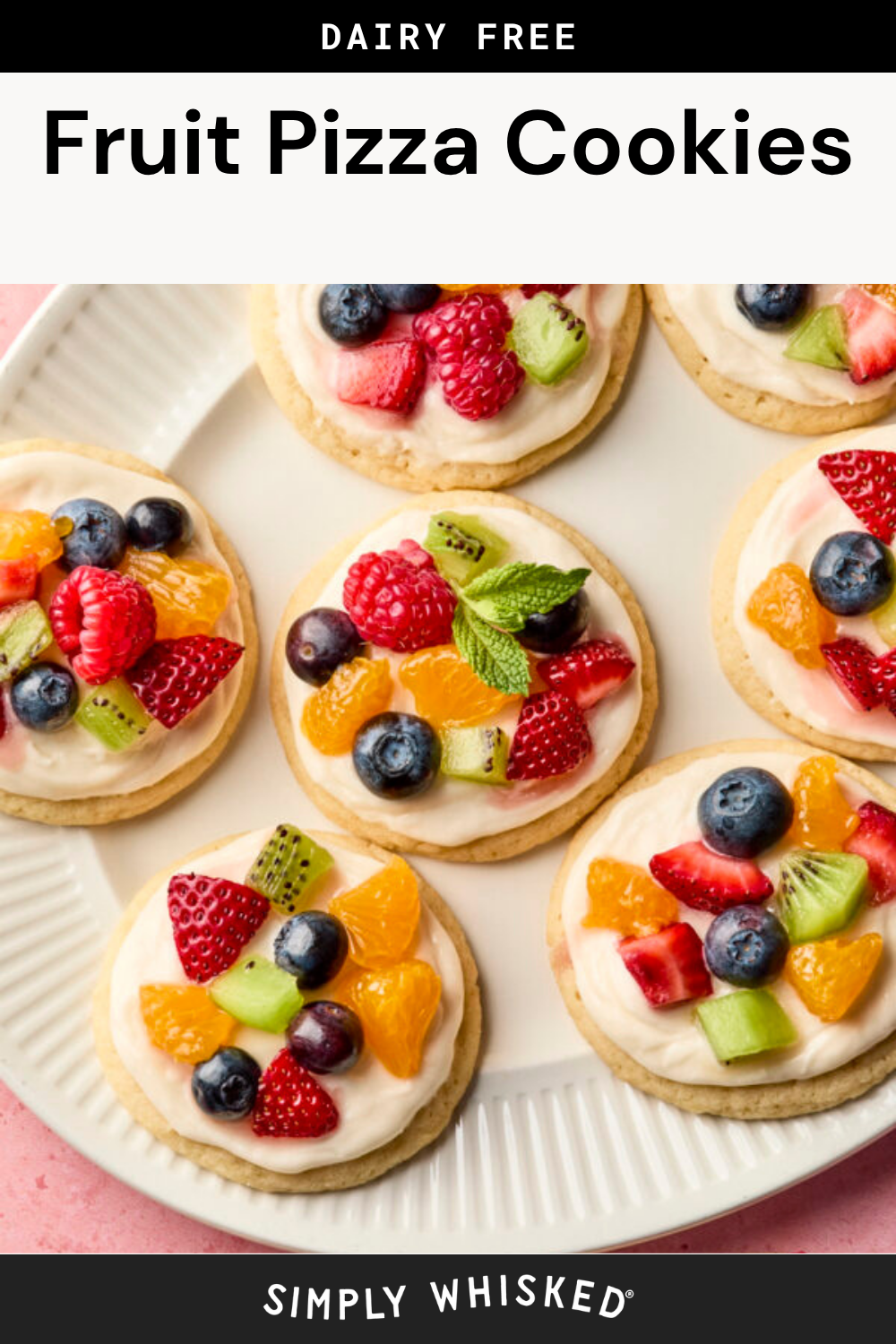A plate of round fruit pizza cookies topped with creamy frosting and assorted fresh fruit, including strawberries, blueberries, raspberries, kiwi, and mandarin oranges. The text reads “Dairy Free Fruit Pizza Cookies.”.