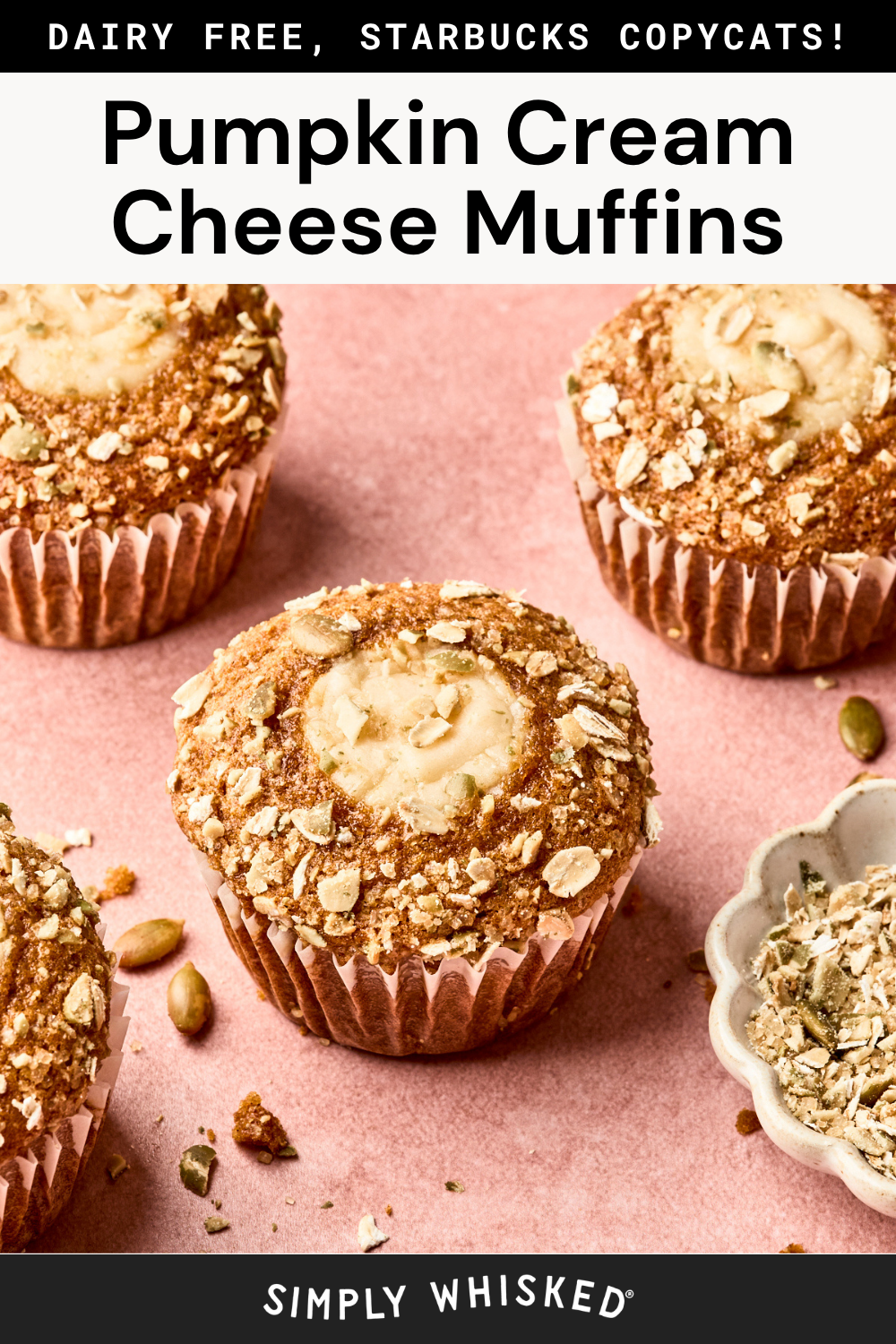 Four pumpkin cream cheese muffins topped with oats and seeds are arranged on a pink surface, with a small bowl of oat topping nearby. Text at the top reads Pumpkin Cream Cheese Muffins, highlighting these delicious pumpkin cream cheese muffins as the perfect autumn treat.