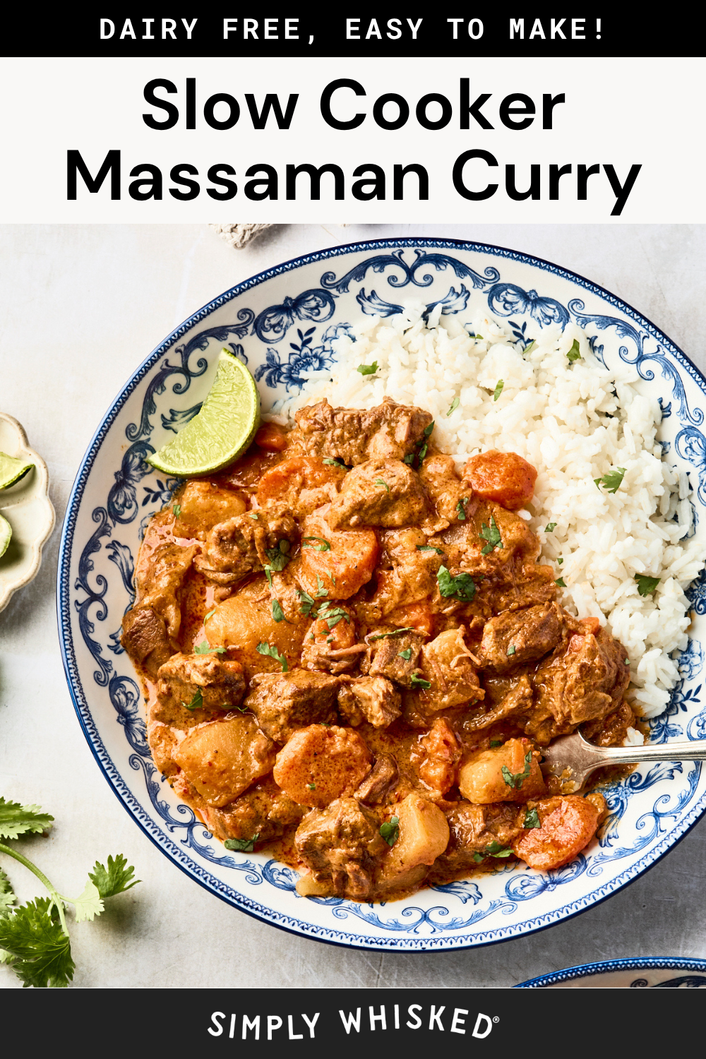A plate of massaman beef curry with tender beef, potatoes, and carrots served alongside white rice, garnished with cilantro and a lime wedge on a blue and white dish.