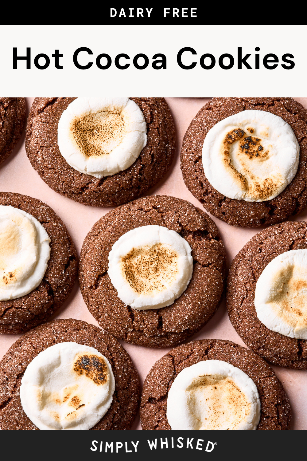 Nine chocolate cookies topped with toasted marshmallows are arranged on a light surface. The text above and below the image reads Hot Cocoa Cookies and Simply Whisked.