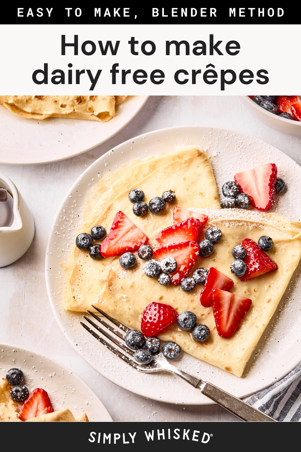 A plate with folded dairy free crepes topped with sliced strawberries, blueberries, and powdered sugar. A fork, a small pitcher of syrup, and extra plates of dairy free crepes sit nearby on a light surface. Text reads: How to make dairy free crêpes.