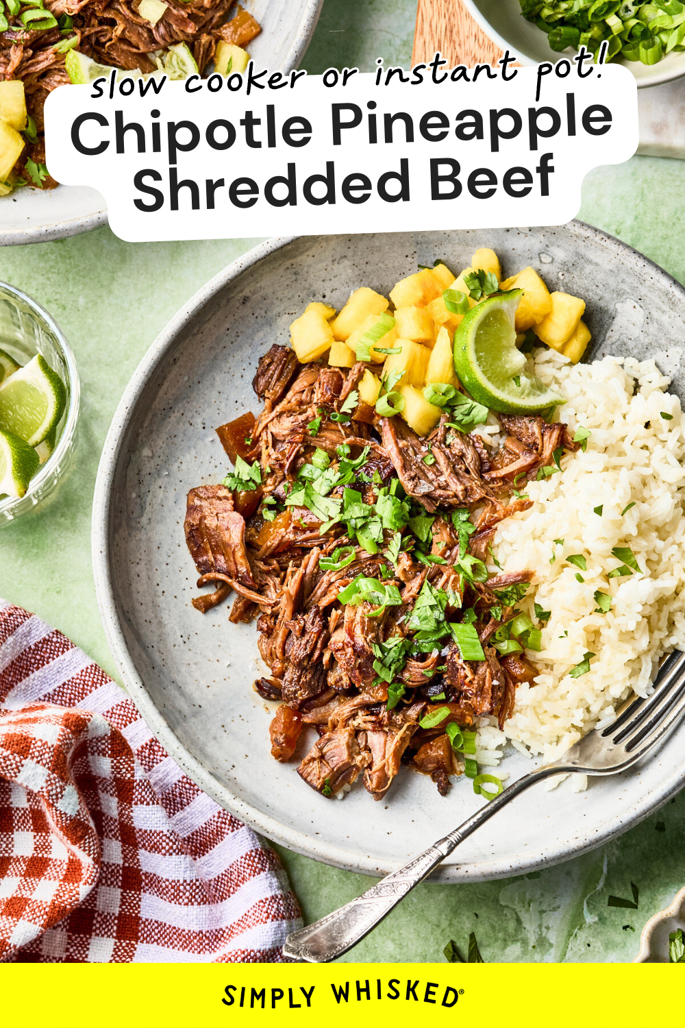 A plate with chipotle pineapple beef, white rice, and pineapple salsa garnished with cilantro and lime. There’s a fork on the plate, a drink and bowl of lime wedges nearby, and a red-checked napkin on the side.