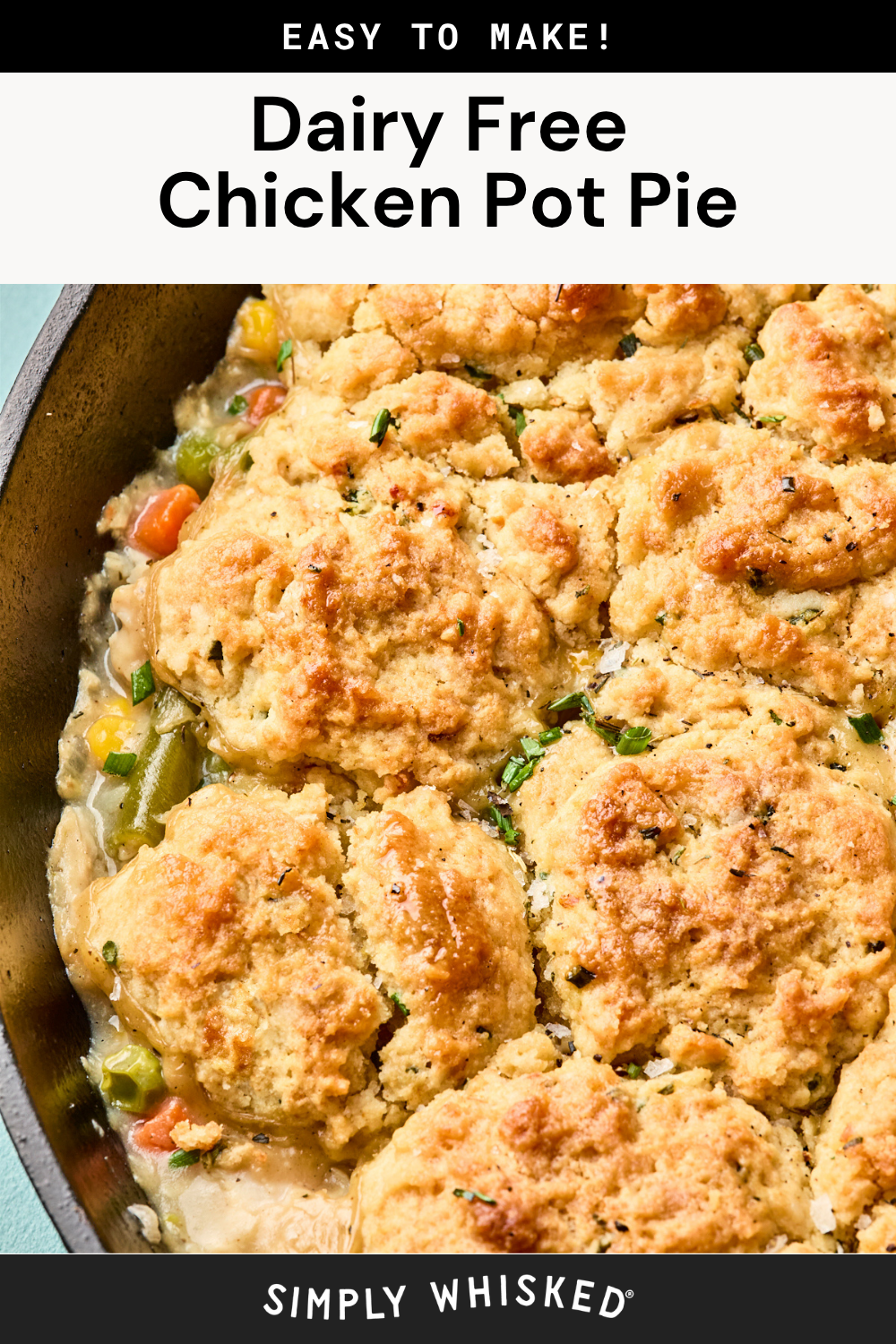 A close-up of an easy chicken pot pie with biscuits in a skillet, topped with golden-brown biscuits and filled with vegetables. Text above and below describes the dish as Dairy Free Chicken Pot Pie and Simply Whisked.