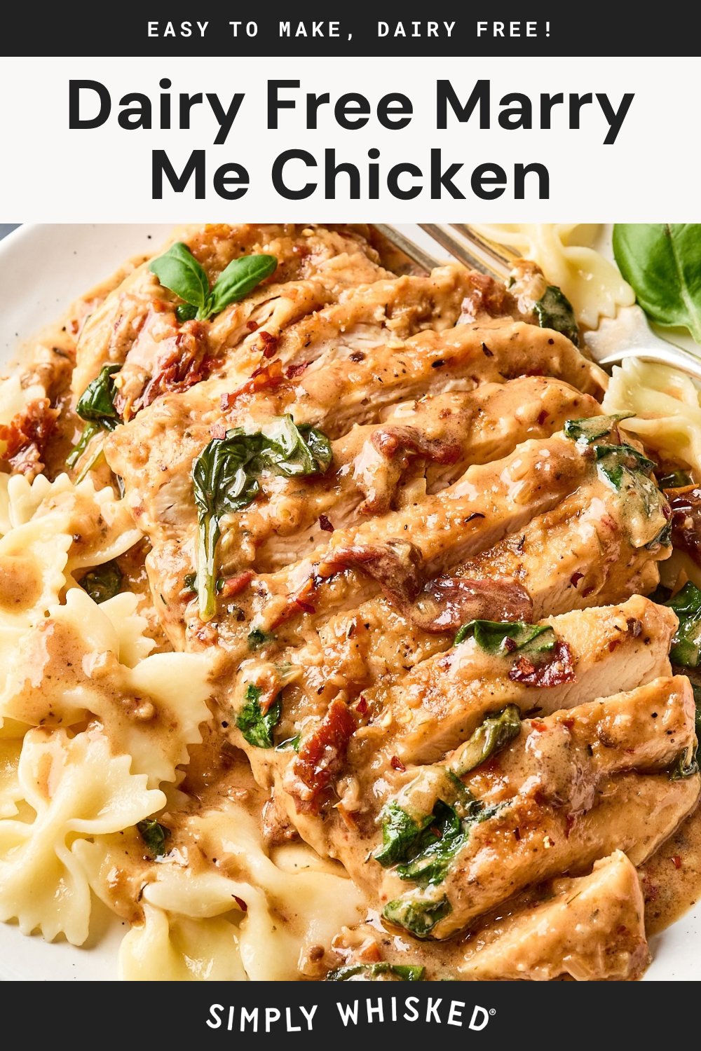 Sliced chicken breast with creamy sauce, spinach, and sun-dried tomatoes on a plate with bow tie pasta, garnished with fresh basil. Text: Dairy Free Marry Me Chicken..